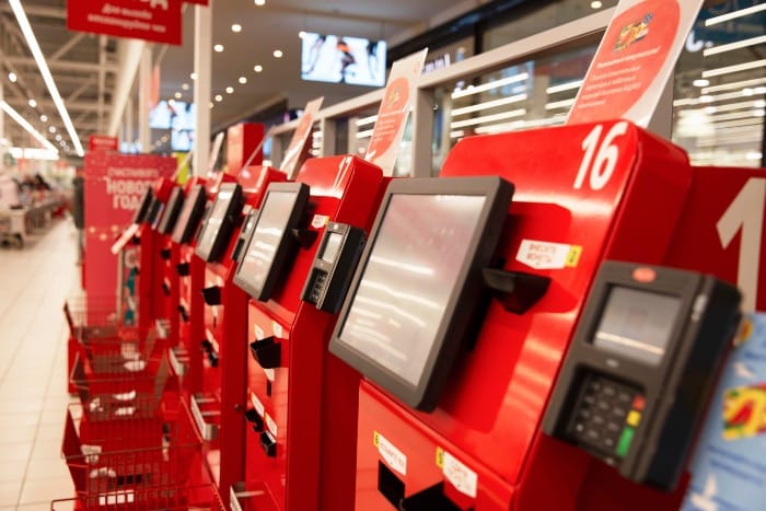 Long row of self-serve checkout machines